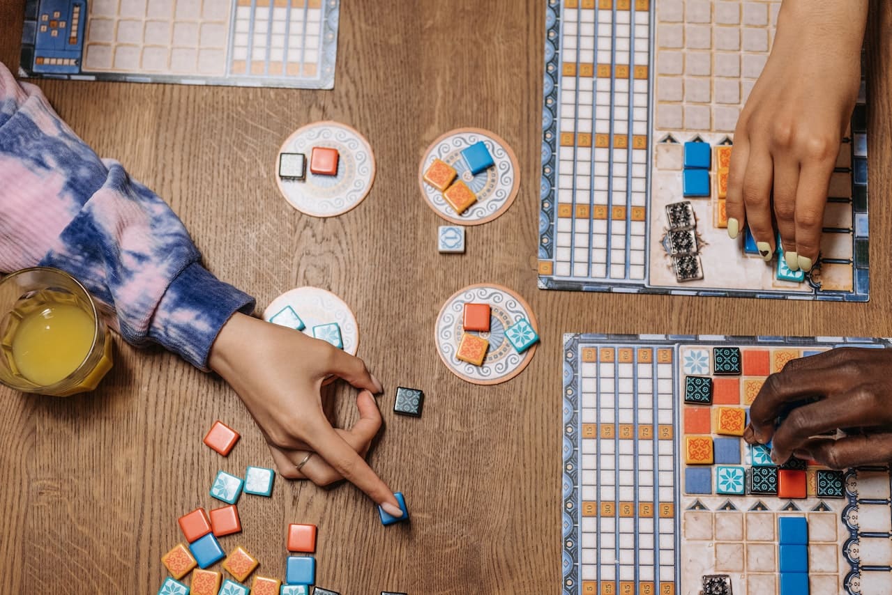 How to make a board game image of hands playing a game